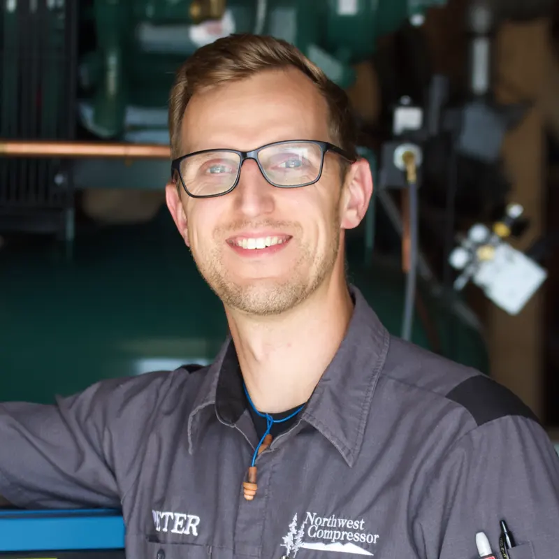 Peter Ramsing smiling in the Northwest Compressor shop